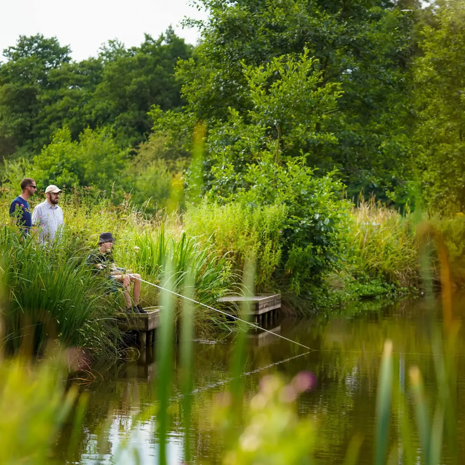 Anglers at the fishing lake on the park