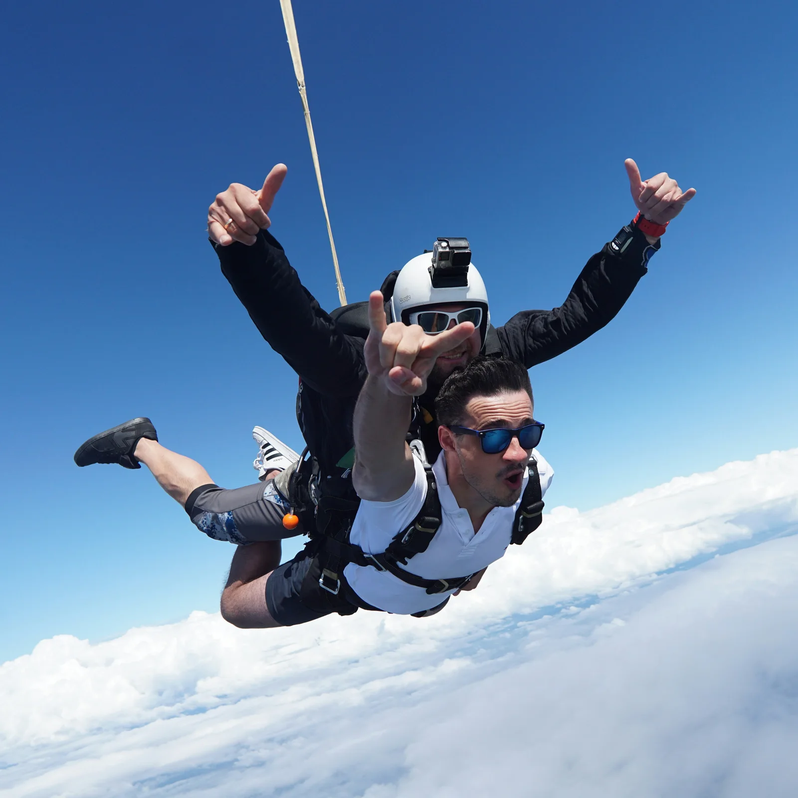 A tandem skydive above the clouds